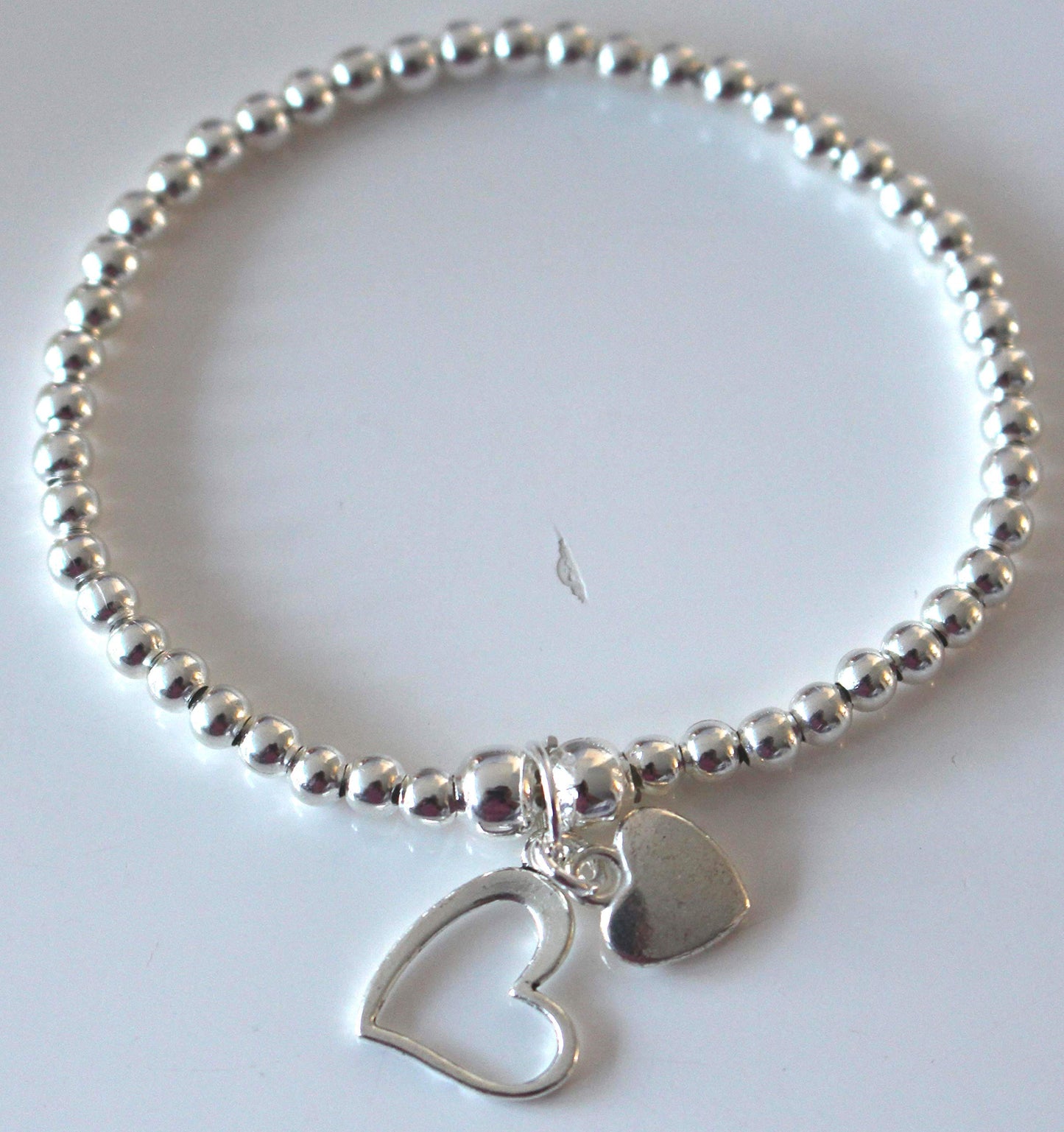 Silver Colour Round Beads With Heart Charms Stretchable Bracelet